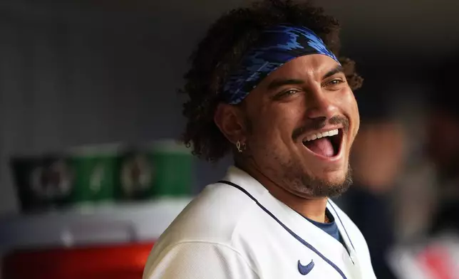 Seattle Mariners' Josh Naylor laughs in the dugout during the sixth inning of a baseball game against the Houston Astros, Monday, April 13, 2026, in Seattle. (AP Photo/Lindsey Wasson)