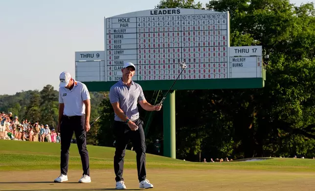 Rory McIlroy, of Northern Ireland, waves after his putt on the 18th hole during the third round of the Masters golf tournament at the Augusta National Golf Club, Saturday, April 11, 2026, in Augusta, Ga. (AP Photo/David J. Phillip)