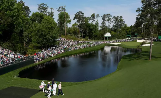 Scottie Scheffler, right, Gary Woodland, center and Johnny Keefer walks to green on the 16th hole during a practice round ahead of the Masters golf tournament at the Augusta National Golf Club, Wednesday, April 8, 2026, in Augusta, Ga. (AP Photo/David J. Phillip)