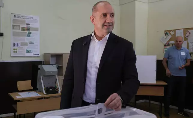 Former Bulgarian President Rumen Radev casts his vote at a polling station in Sofia, Bulgaria, Sunday, April 19, 2026, during early parliamentary elections. (AP Photo/Valentina Petrova)