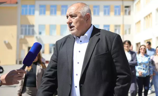 Former Prime Minister Boyko Borissov speaks to journalists after casting his vote in a polling station in Bankya, Bulgaria, Sunday, April 19, 2026, during early parliamentary elections. (AP Photo/Valentina Petrova)