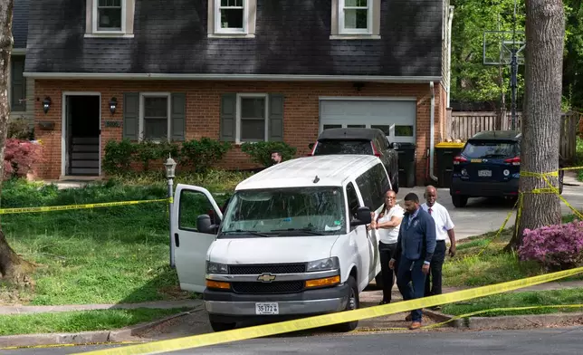 Fairfax County coroners, with two bodies in the van, prepare to leave the home of former Virginia Lt. Gov. Justin Fairfax, in Annandale, Va., Thursday, April 16, 2026. (AP Photo/Cliff Owen)