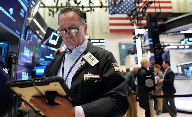 Ed Curran works on the floor at the New York Stock Exchange in New York, Tuesday, April 7, 2026. (AP Photo/Seth Wenig)