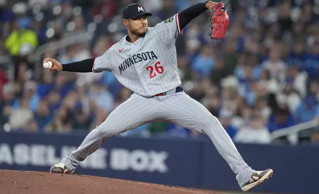 Minnesota Twins pitcher Taj Bradley throws against the Toronto Blue Jays during first-inning baseball game action in Toronto, Sunday, April 12, 2026. (Nathan Denette/The Canadian Press via AP)