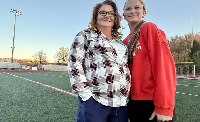 Heather Jackson, left, and her daughter, Becky Pepper-Jackson, pose for a portrait Tuesday, April 7, 2026, at Bridgeport High School in Bridgeport, W.Va. (AP Photo/John Raby)