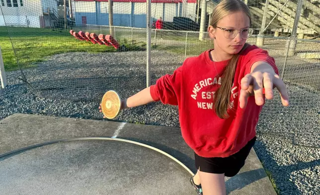 Becky Pepper-Jackson prepares to throw a discus Tuesday, April 7, 2026, at Bridgeport High School in Bridgeport, W.VA. (AP Photo/John Raby)