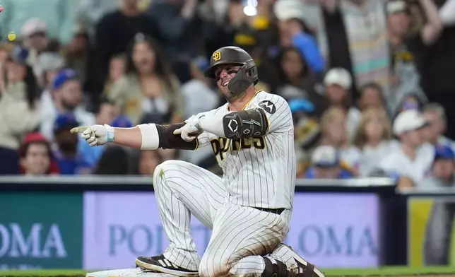 San Diego Padres' Ty France celebrates his two-RBI triple during the eighth inning of a baseball game against the Chicago Cubs Monday, April 27, 2026, in San Diego. (AP Photo/Gregory Bull)