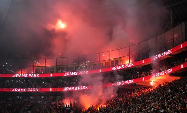 Fenerbahce's supporters light flares during a Turkish Super Lig soccer match between Galatasaray and Fenerbahce in Istanbul, Turkey, Sunday, April 26, 2026. (AP Photo/Emrah Gurel)