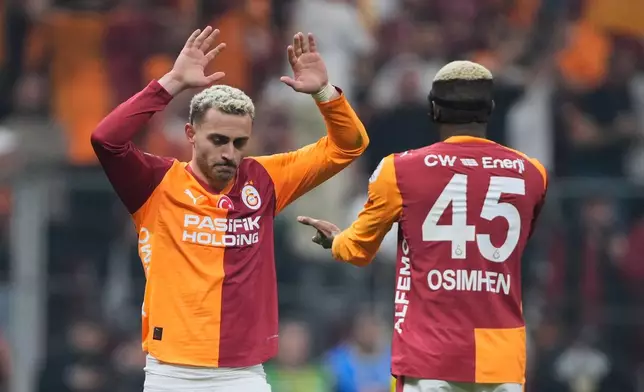 Galatasaray's Baris Yilmaz, left, celebrates with teammate Victor Osimhen after scoring their side's second goal during a Turkish Super Lig soccer match between Galatasaray and Fenerbahce in Istanbul, Turkey, Sunday, April 26, 2026. (AP Photo/Emrah Gurel)
