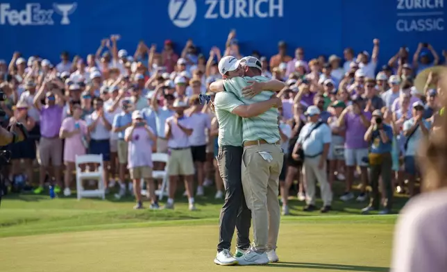 Alex Fitzpatrick, right, of England, reacts after sinking a birdie putt and winning the tournament with his brother Matt Fitzpatrick, left, during the final round of the PGA Zurich Classic of New Orleans golf tournament, Sunday, April 26, 2026, in Avondale, La. (AP Photo/Matthew Hinton)