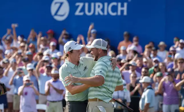 Alex Fitzpatrick, right, of England, reacts after sinking a birdie putt and winning the tournament with his brother Matt Fitzpatrick, left, during the final round of the PGA Zurich Classic of New Orleans golf tournament, Sunday, April 26, 2026, in Avondale, La. (AP Photo/Matthew Hinton)