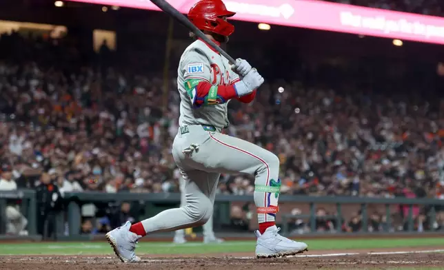 Philadelphia Phillies' Bryce Harper watches his two-run single against the San Francisco Giants during the seventh inning of a baseball game in San Francisco, Monday, April 6, 2026. (AP Photo/Jed Jacobsohn)