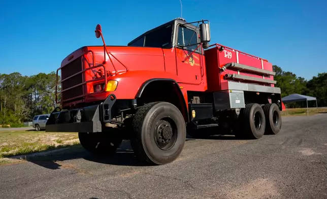 Fire crews and truck assemble at the Brantley County Airport as they work the Brantley highway 82 fire, Thursday, April 23, 2026, near Nahunta, Ga. (AP Photo/Mike Stewart)