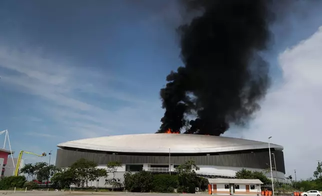 The roof of Rio de Janeiro's Olympic Park velodrome is on fire, Wednesday, April 8, 2026. (AP Photo/Bruna Prado)
