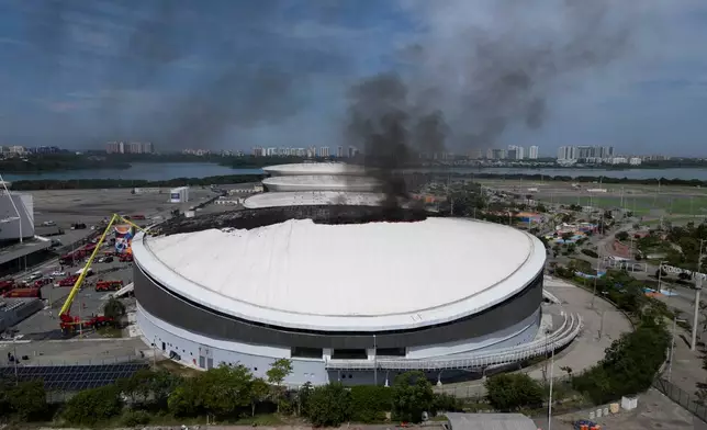 The roof of the Rio de Janeiro's Olympic Park velodrome is on fire, Wednesday, April 8, 2026. (AP Photo/Bruna Prado)
