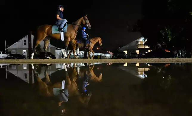 Horses head to the track for a workout at Churchill Downs Tuesday, April 28, 2026, in Louisville, Ky. (AP Photo/Charlie Riedel)