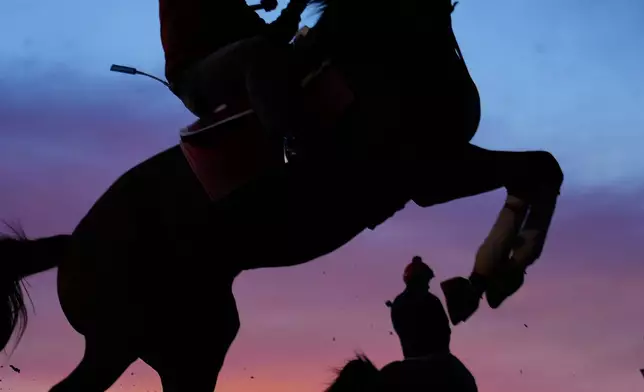 Horses come off the track after a workout at Churchill Downs Monday, April 27, 2026, in Louisville, Ky. (AP Photo/Charlie Riedel)