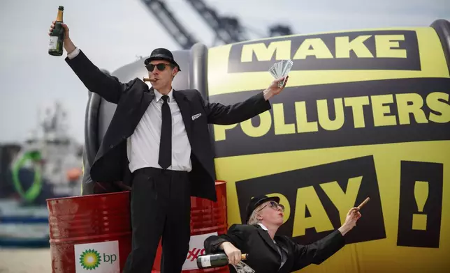 Demonstrators participate in a Make Polluters Pay campaign along the Caribbean Sea demanding oil companies pay for the energy transition during a nearby conference aimed at transitioning away from fossil fuels Monday, April 27, 2026, in Santa Marta, Colombia. (AP Photo/Ivan Valencia)