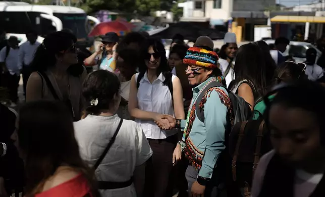 Attendees line up to enter at the University of Magdalena for a conference aimed at transitioning away from fossil fuels Monday, April 27, 2026, in Santa Marta, Colombia. (AP Photo/Ivan Valencia)
