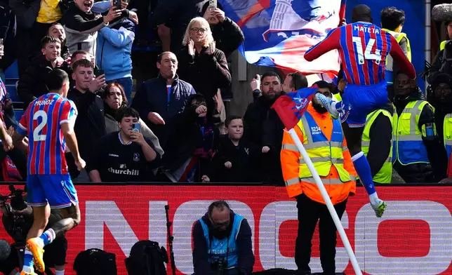 Crystal Palace's Jean-Philippe Mateta (right) celebrates scoring during the English Premier League soccer match between Crystal Palace and Newcastle United in London., Sunday April 12, 2026. (Jordan Pettitt/PA via AP)