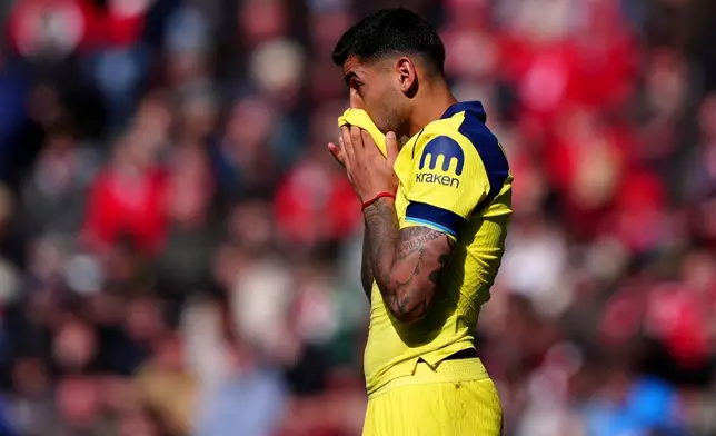 Tottenham Hotspur's Cristian Romero reacts after colliding with his team mate Tottenham Hotspur goalkeeper Antonin Kinsky during the Premier League soccer match between Sunderland and Tottenham Hotspur, in Sunderland, England, Sunday April 12, 2026. (Owen Humphreys/PA via AP)