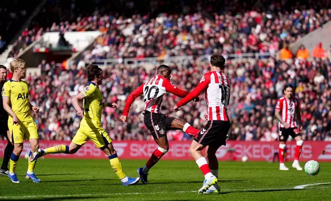 Sunderland's Nordi Mukiele, centre, scores his side's first goal of the game during the Premier League soccer match between Sunderland and Tottenham Hotspur, in Sunderland, England, Sunday April 12, 2026. (Owen Humphreys/PA via AP)