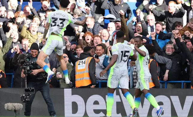 Manchester City's Nico O'Reilly celebrates after scoring during the Premier League soccer match between Chelsea and Manchester City in London, Sunday, April 12, 2026. (AP Photo/Ian Walton)