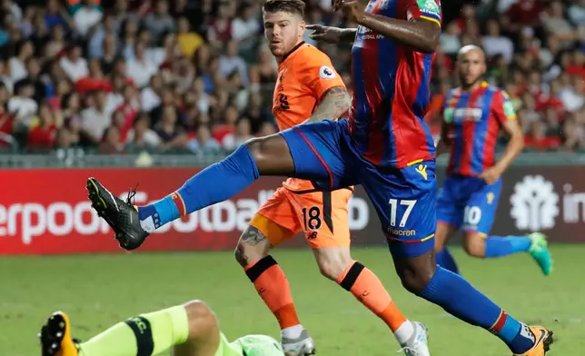FILE - Christian Benteke of Crystal Palace FC, top, jumps as he is blocked by Simon Mignolet, goalkeeper of Liverpool FC, bottom, during a day one match at the Premier League Asia Trophy soccer tournament in Hong Kong, July 19, 2017. (AP Photo/Kin Cheung, File)