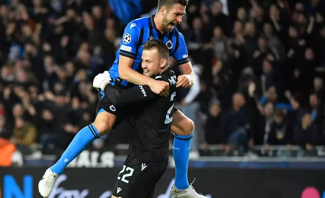 FILE - Brugge's goalkeeper Simon Mignolet, right, celebrates after Brugge's won the Champions League Group B soccer match between Club Brugge and Atletico Madrid at the Jan Breydel stadium in Bruges, Belgium, Oct. 4, 2022. (AP Photo/Geert Vanden Wijngaert, File)