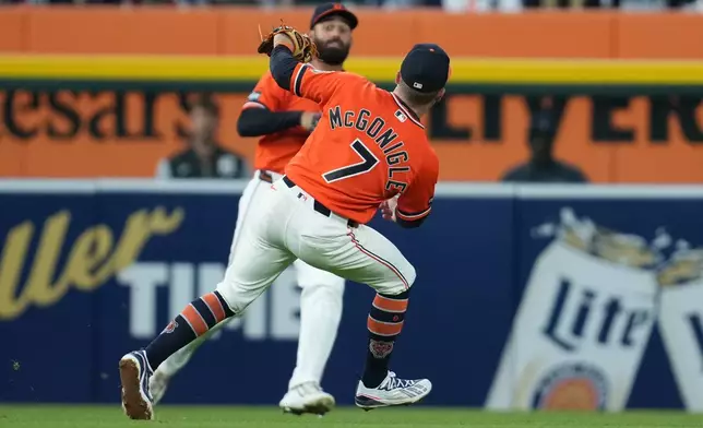 Detroit Tigers left fielder Riley Greene and shortstop Kevin McGonigle (7) let a Miami Marlins' Connor Norby fly ball land for a double during the fifth inning of a baseball game Friday, April 10, 2026, in Detroit. (AP Photo/Paul Sancya)