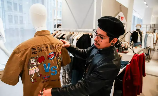 Tailor Marco Lema, 35, of Ecuador, works on an embroidered shirt at Nordstrom headquarters in New York, Monday, March 23, 2026. (AP Photo/Eduardo Munoz Alvarez)