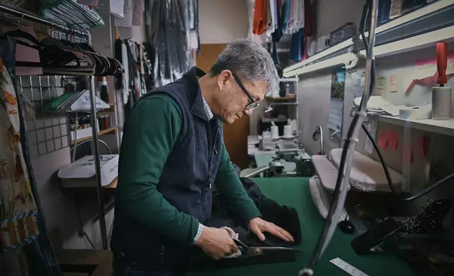 Tailor, Kil Bae, works inside his shop on Friday, March 27, 2026, in New York. (AP Photo/Andres Kudacki)
