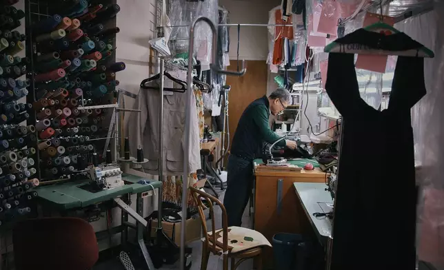 Tailor, Kil Bae, works inside his shop on Friday, March 27, 2026, in New York. (AP Photo/Andres Kudacki)