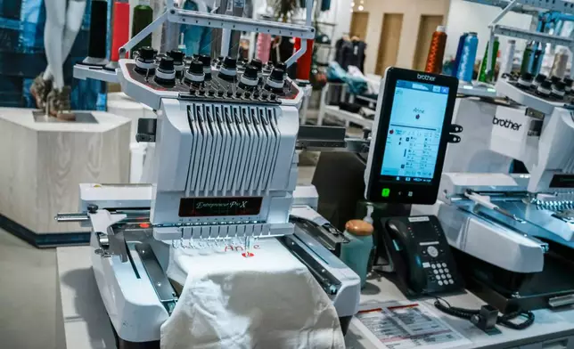 An embroidery machine works on a decoration at Nordstrom headquarters in New York, Monday, March 23, 2026. (AP Photo/Eduardo Munoz Alvarez)