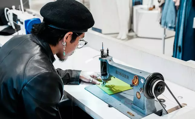 Tailor Marco Lema, 35, of Ecuador, works on a embroidery machine at Nordstrom headquarters in New York, Monday, March 23, 2026. (AP Photo/Eduardo Munoz Alvarez)