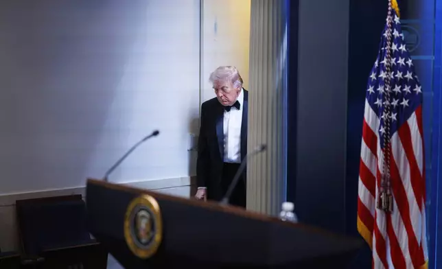 President Donald Trump arrives at the James Brady Press Briefing Room at the White House after a shooting incident outside the ballroom at the annual White House Correspondents' Association Dinner in Washington, Saturday, April 25, 2026. (AP Photo/Tom Brenner)