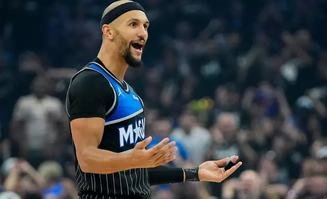 Orlando Magic guard Jalen Suggs interacts with fans after sinking a 3-point shot against the Detroit Pistons during the first half in Game 3 of a first-round NBA basketball playoff series basketball game, Saturday, April 25, 2026, in Orlando, Fla. (AP Photo/John Raoux)