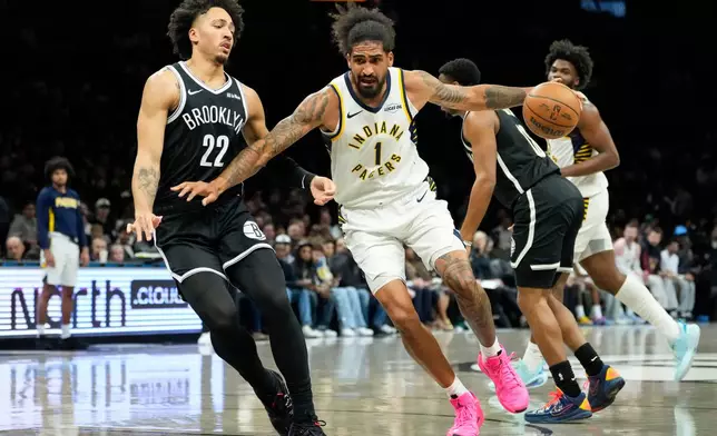 Indiana Pacers forward Obi Toppin (1) drives past Brooklyn Nets forward Jalen Wilson (22) during the first half of an NBA basketball game, Thursday, April 9, 2026, in New York. (AP Photo/Yuki Iwamura)