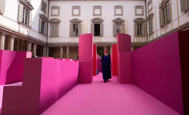 Designer Lina Ghotmeh walks through her installation 'Metamorphosis in motion' at Palazzo Litta, during the Design Week in Milan, Italy, Monday, April 20, 2026. (AP Photo/Luca Bruno)