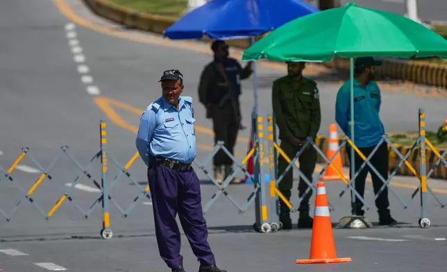 Police officers stand guard at a checkpoint to ensure security in Islamabad, Pakistan, Wednesday, April 22, 2026. (AP Photo/Anjum Naveed)