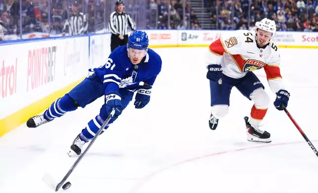 Toronto Maple Leafs' Michael Pezzetta (61) skates the puck past Florida Panthers' Ludvig Jansson (54) during second period NHL action in Toronto on Saturday, April 11, 2026. (Cole Burston/The Canadian Press via AP)