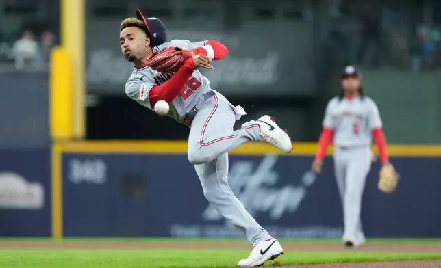 Washington Nationals' Nasim Nuñez throws to first base during the fourth inning of a baseball game against the Milwaukee Brewers, Sunday, April 12, 2026, in Milwaukee. (AP Photo/Aaron Gash)