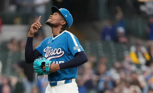 Milwaukee Brewers' Abner Uribe gestures as he walks to the dugout during the seventh inning of a baseball game against the Washington Nationals, Sunday, April 12, 2026, in Milwaukee. (AP Photo/Aaron Gash)