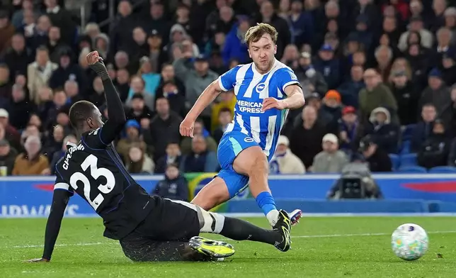 Brighton and Hove Albion's Jack Hinshelwood, right, scores their second goal during the Premier League soccer match between Brighton and Hove Albion and Chelsea, Tuesday, April 21 2026, in Brighton, England. (Gareth Fuller/PA via AP)