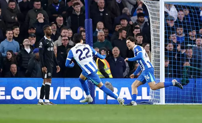 Brighton and Hove Albion's Ferdi Kadioglu, right, celebrates scoring their side's first goal during the English Premier League soccer match between Brighton &amp; Hove Albion and Chelsea in Brighton, England, Tuesday, April 21, 2026. (Gareth Fuller/PA via AP)