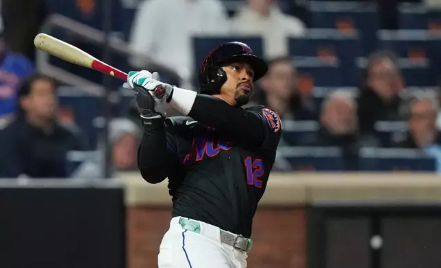 New York Mets' Francisco Lindor follows through on a three-run home run during the third inning of a baseball game against the Minnesota Twins Tuesday, April 21, 2026, in New York. (AP Photo/Frank Franklin II)