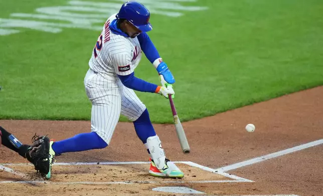 New York Mets' Francisco Lindor hits an RBI single during the first inning of a baseball game against the Minnesota Twins Wednesday, April 22, 2026, in New York. (AP Photo/Frank Franklin II)