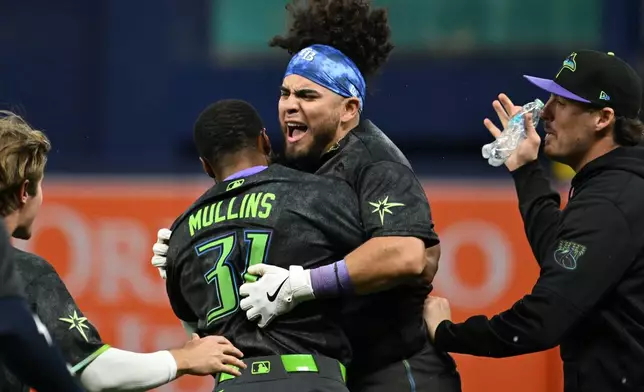 Tampa Bay Rays' Cedric Mullins (31) and Jonathan Aranda celebrate after Aranda's RBI walk-off single during the tenth inning of a baseball game against the New York Yankees Saturday, April 11, 2026, in St. Petersburg, Fla. (AP Photo/Jason Behnken)