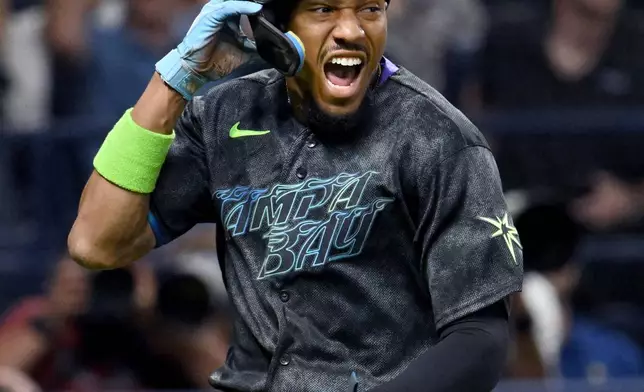 Tampa Bay Rays' Chandler Simpson celebrates after scoring on a walk-off infield single by Jonathan Aranda, not pictured, during the tenth inning of a baseball game against the New York Yankees Saturday, April 11, 2026, in St. Petersburg, Fla. (AP Photo/Jason Behnken)