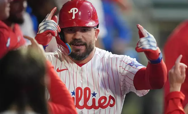 Philadelphia Phillies' Kyle Schwarber celebrates after hitting a home run off of Washington Nationals pitcher Zack Littell during the third inning of a baseball game, Tuesday, March 31, 2026, in Philadelphia. (AP Photo/Matt Rourke)